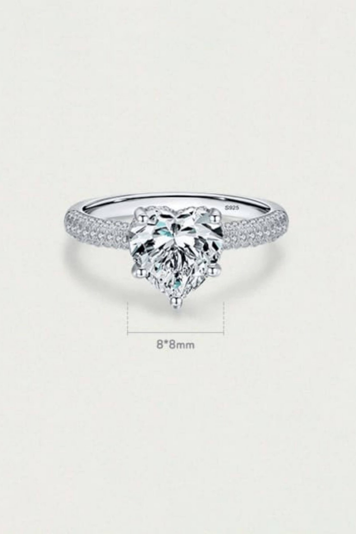 a diamond ring with a heart shaped stone