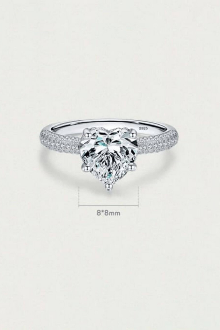 a diamond ring with a heart shaped stone