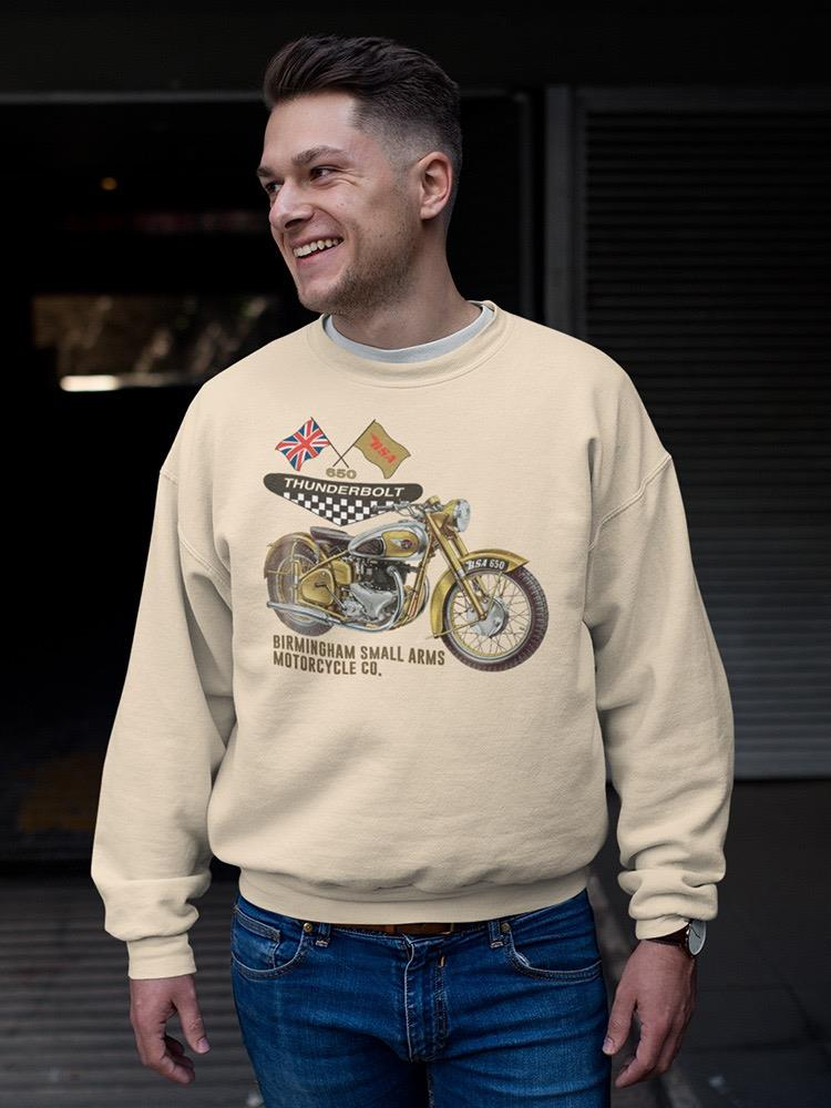 a man smiling in a sweatshirt