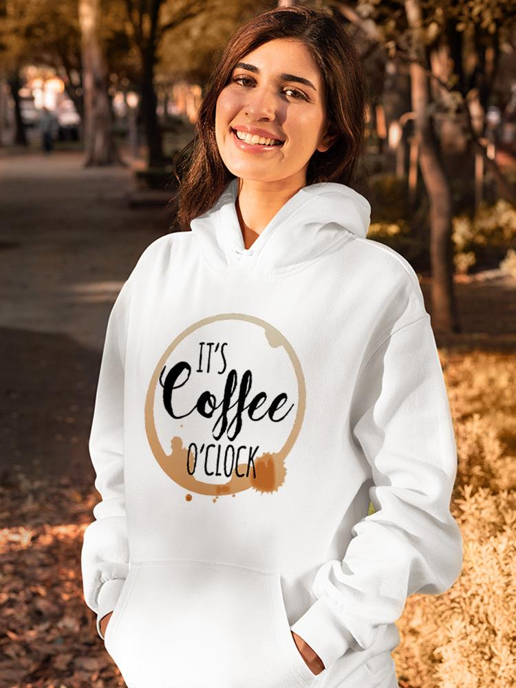 a woman smiling in a white sweatshirt