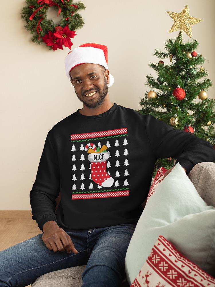 a man wearing a santa hat and sweater sitting on a couch