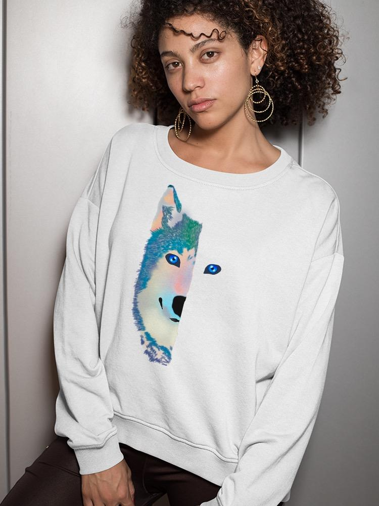 a woman with curly hair wearing a white sweatshirt with a wolf face