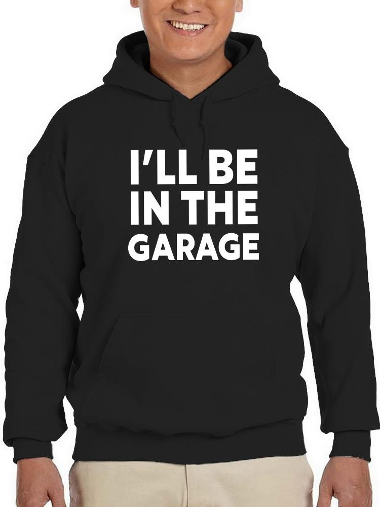 a person wearing a black hoodie with white text