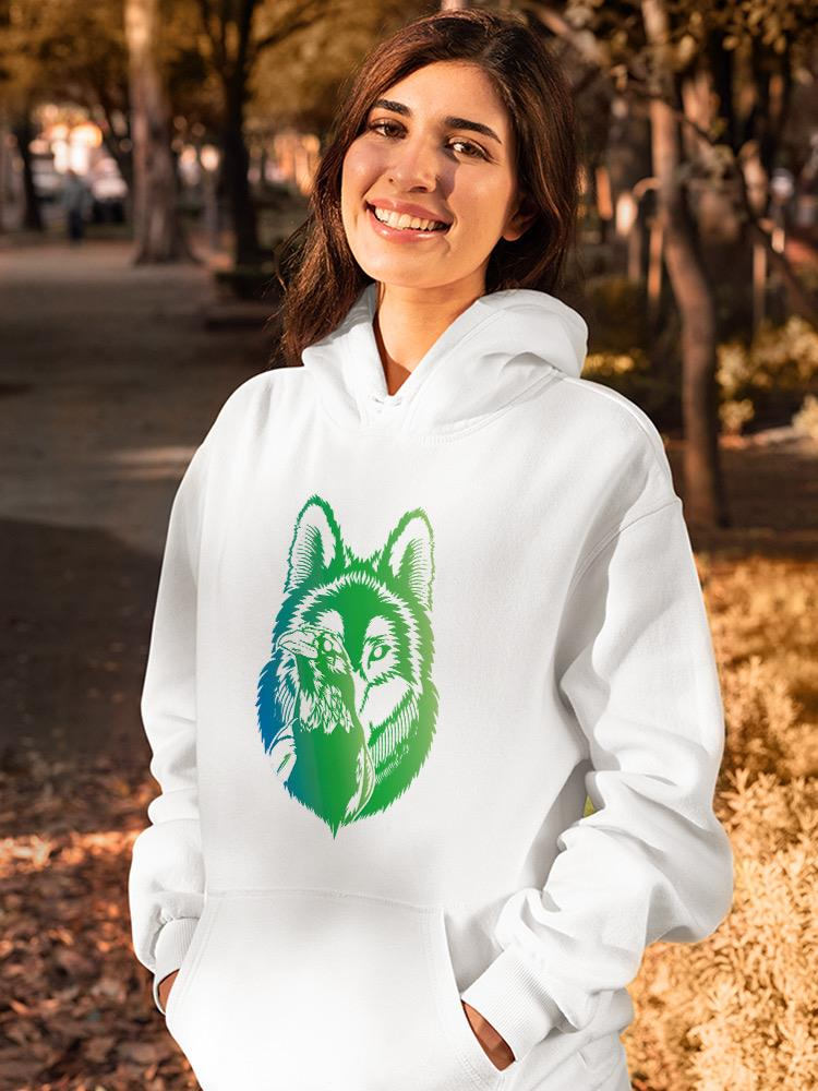 a woman smiling with a white sweatshirt with a wolf on it