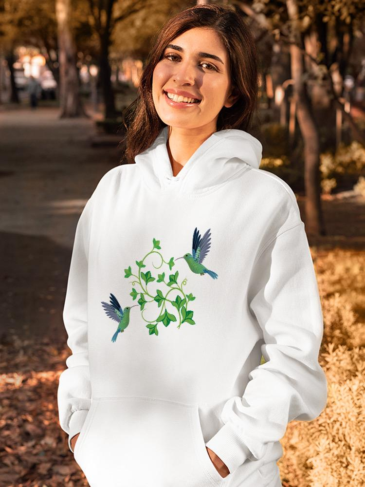a woman smiling with a white sweatshirt with birds on it