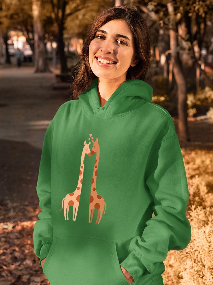 a woman smiling in a green sweatshirt with giraffes on it
