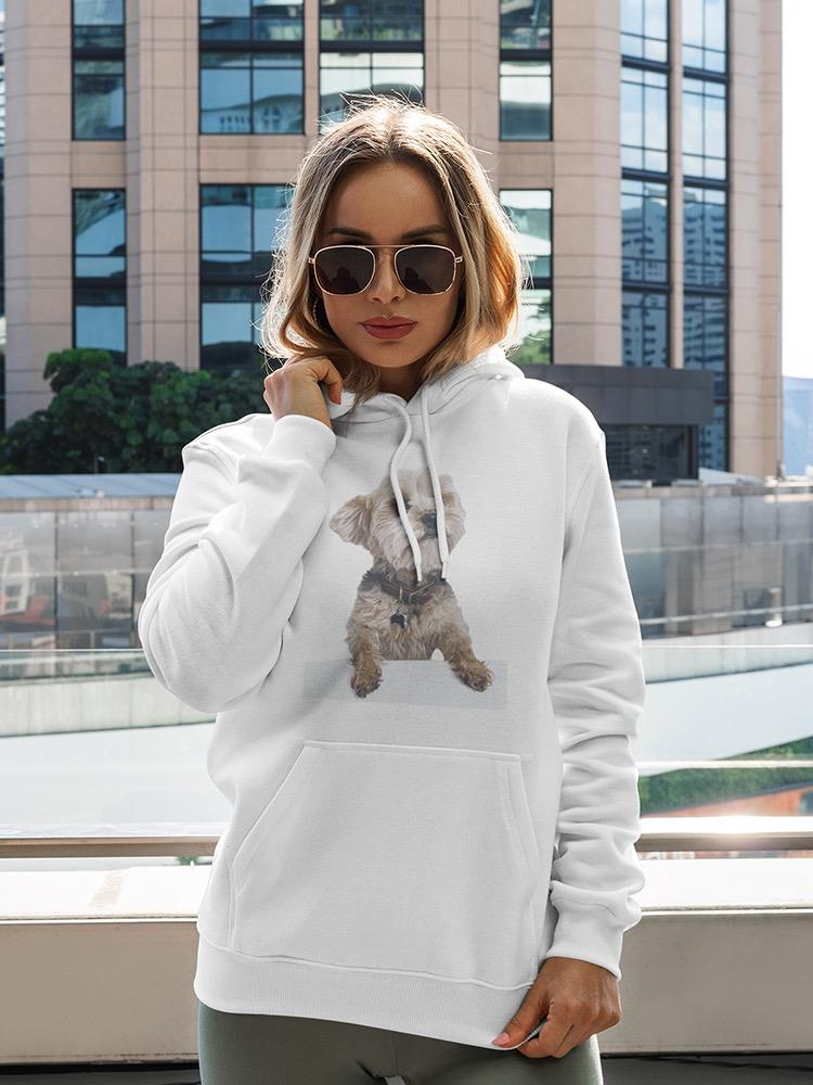 a woman wearing sunglasses and a white hoodie with a dog on it