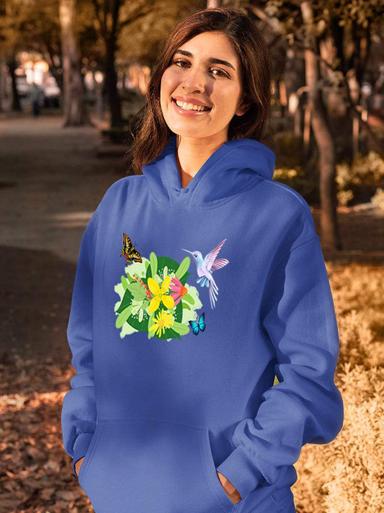 a woman smiling in a blue sweatshirt with butterflies and flowers
