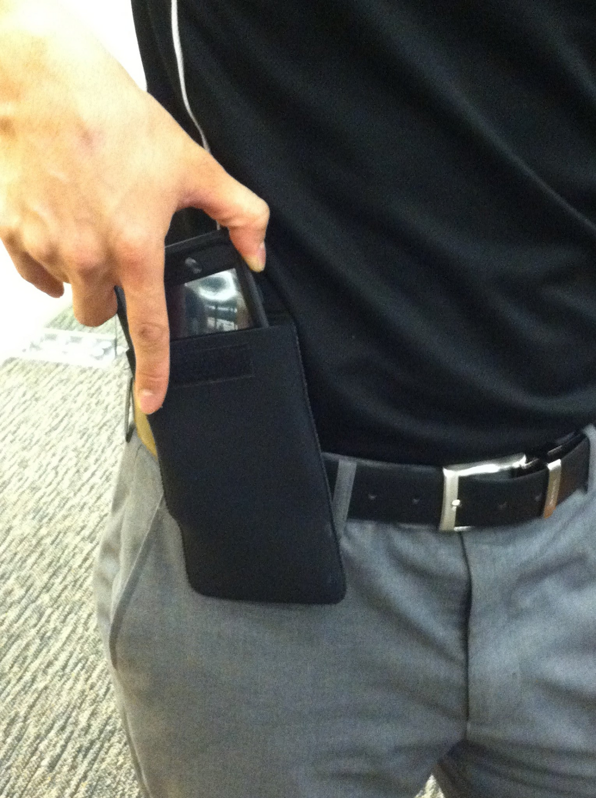 a person holding a phone in their pocket