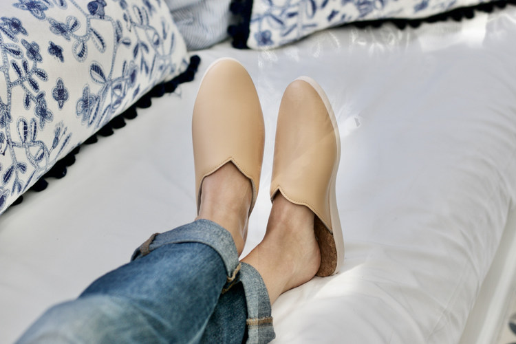 a person's feet with slippers