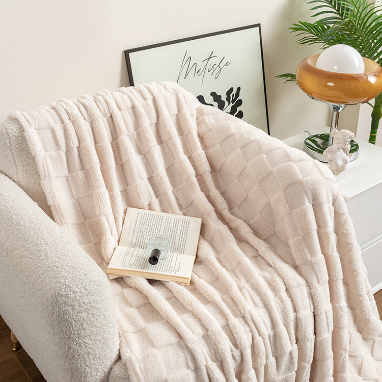 a white blanket on a chair