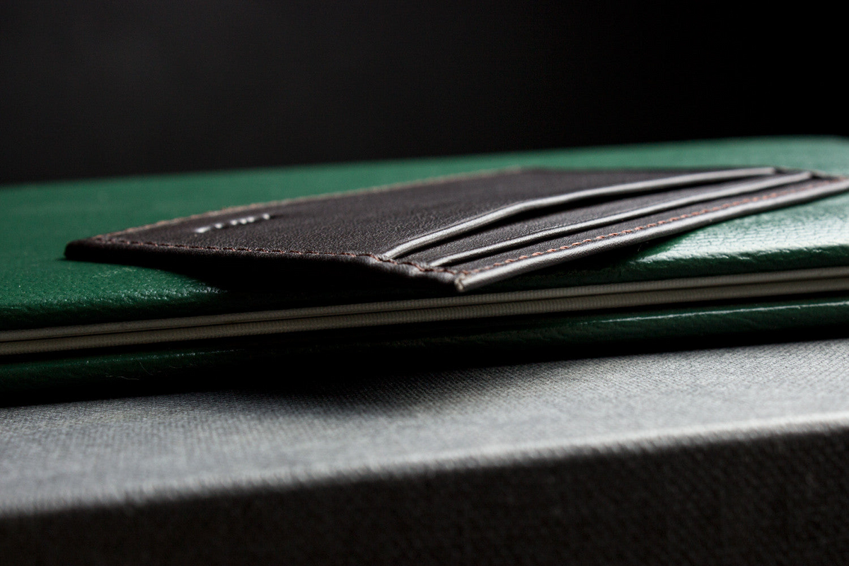 a wallet on a green book