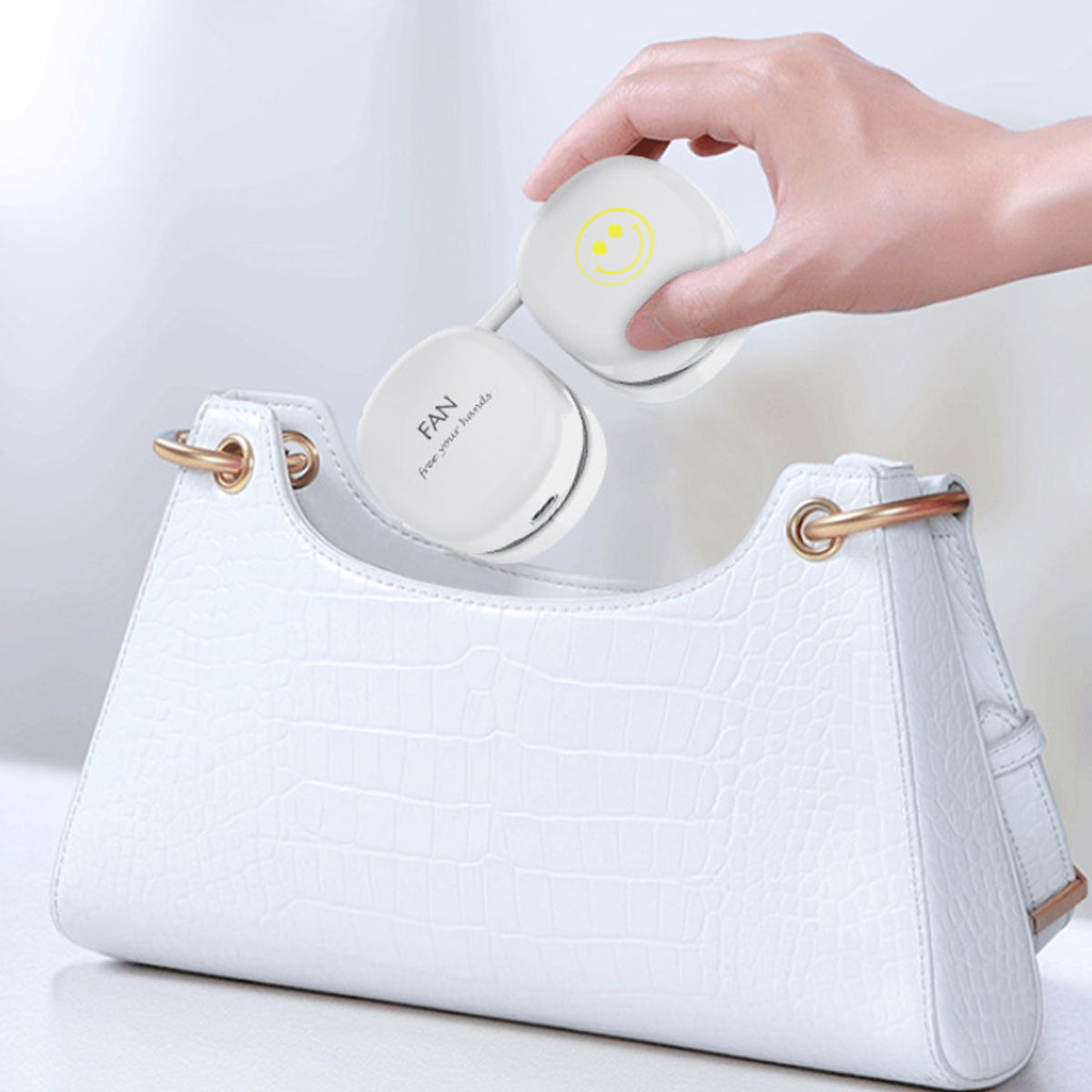 a hand holding a white object