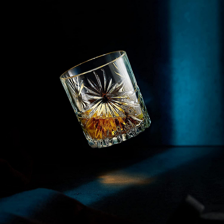 a glass with a drink in the air