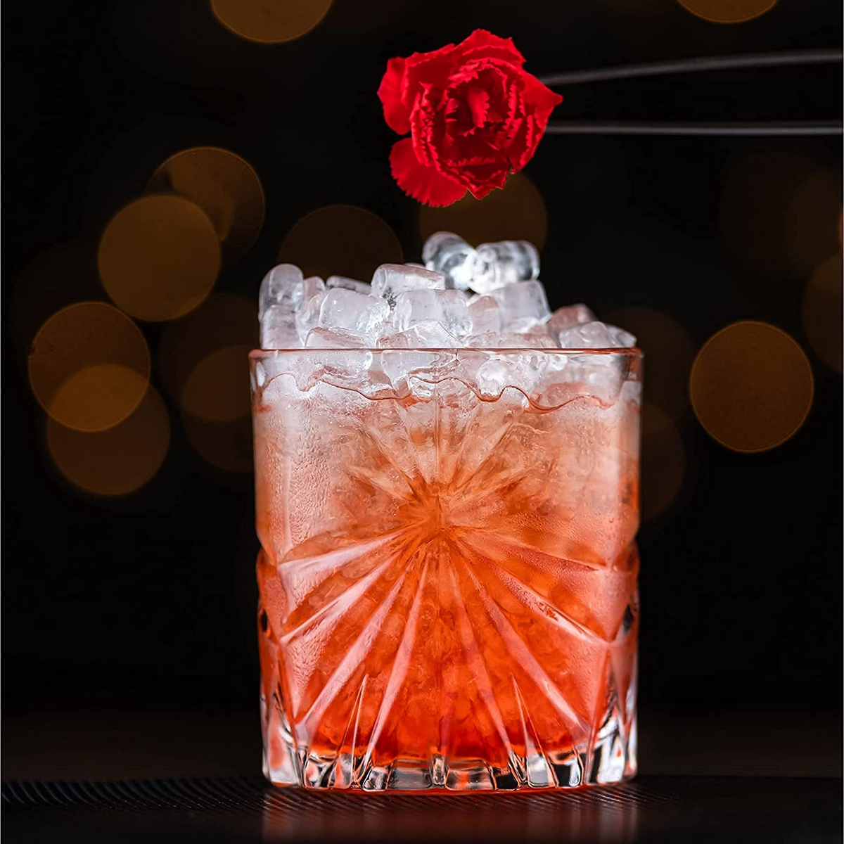 a red rose in a glass with ice and ice