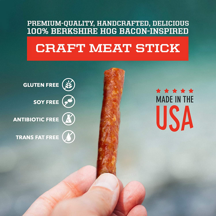 a hand holding a stick of meat