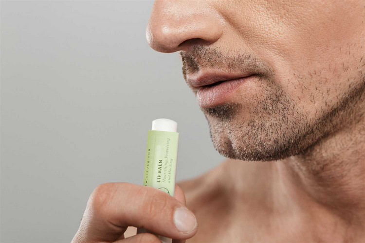 a man holding a lip balm