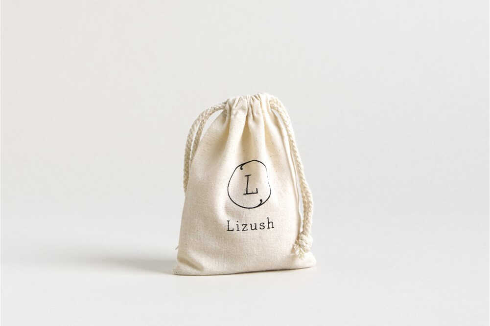 a small white bag with a logo on it