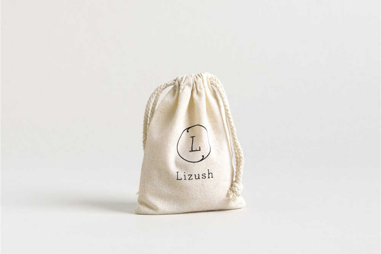 a small white bag with a logo on it