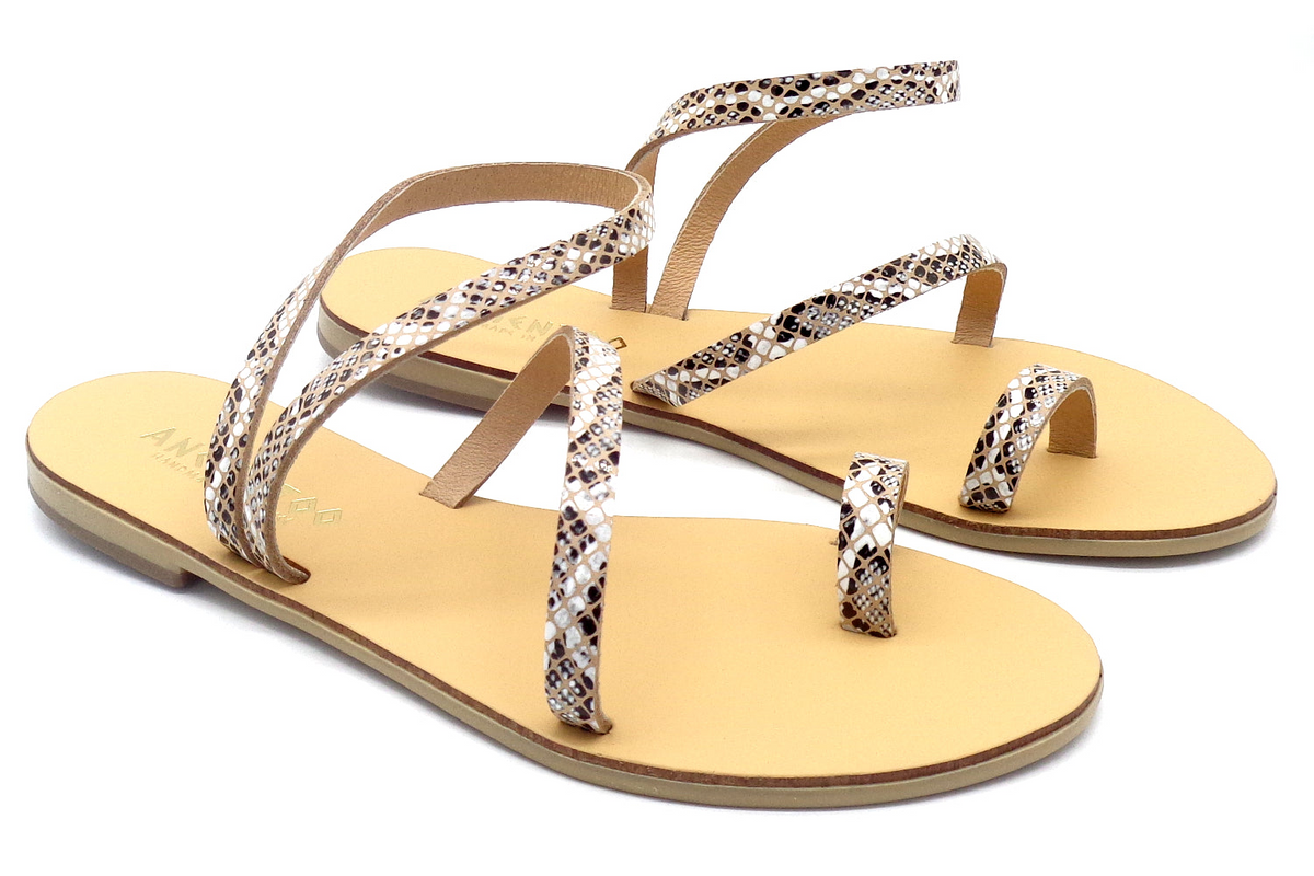 a pair of sandals with a snake print design