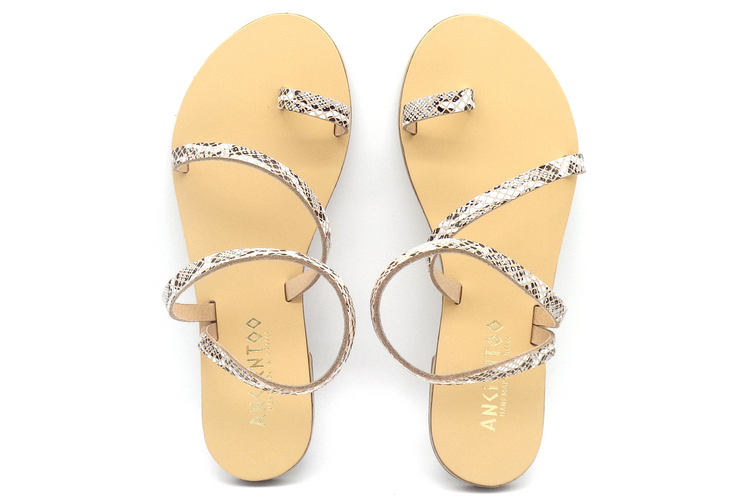 a pair of sandals with snakeskin straps