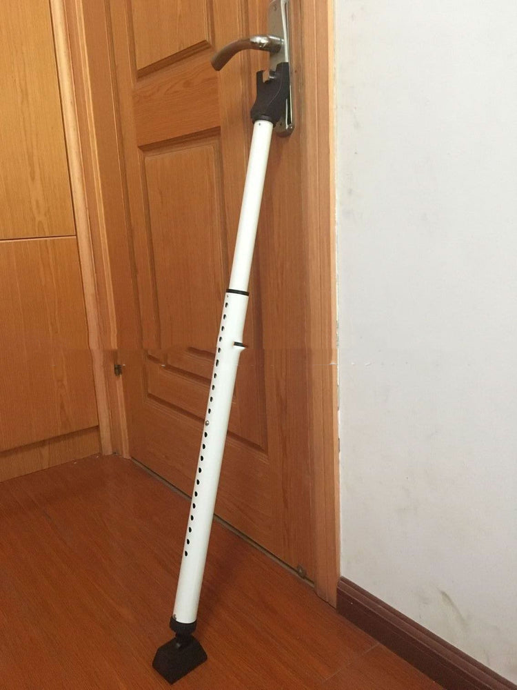 a white pole leaning against a door
