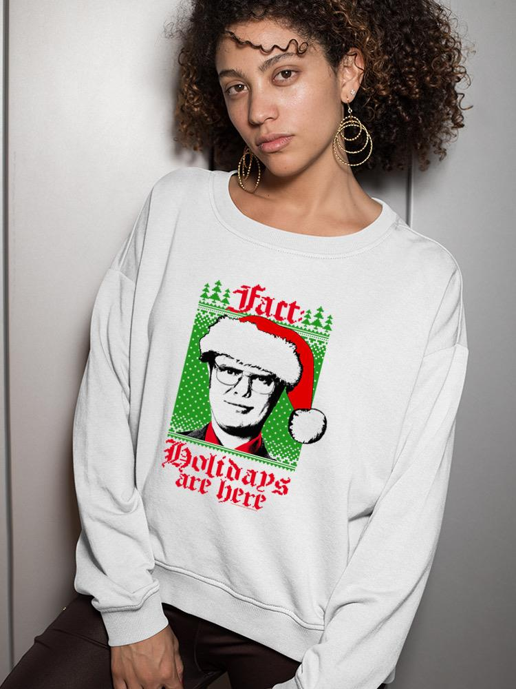 a woman wearing a white sweater with a picture of a man in a santa hat