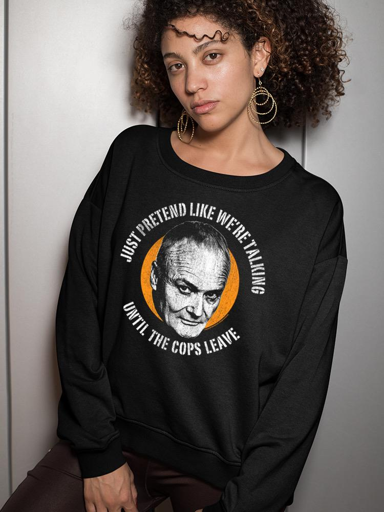 a woman with curly hair wearing a black sweatshirt