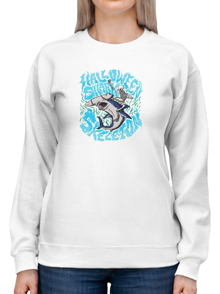 a person wearing a white sweatshirt with a shark on it