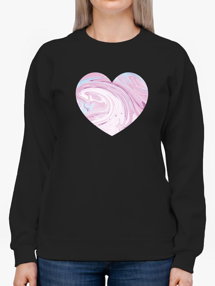 a person wearing a black sweatshirt with a heart on it