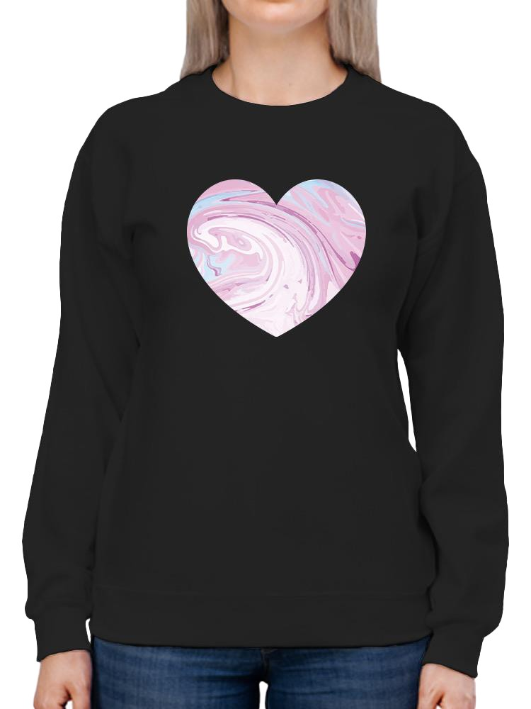 a person wearing a black sweatshirt with a heart on it