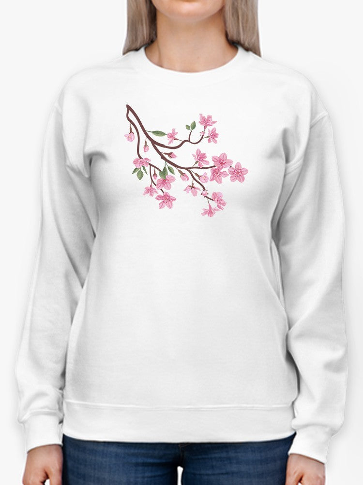 a person wearing a white sweatshirt with pink flowers on it