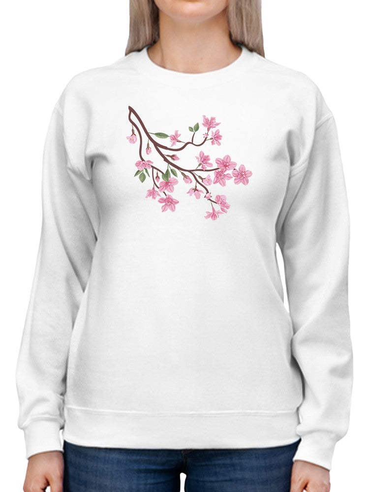 a person wearing a white sweatshirt with pink flowers on it
