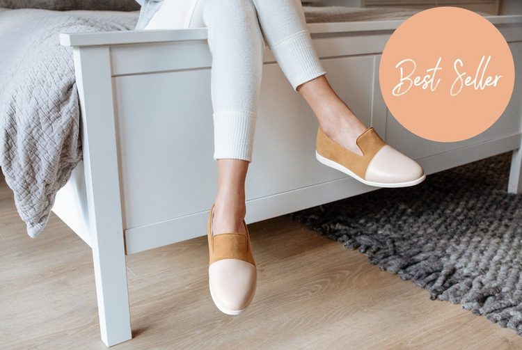 a person's legs and feet in white and brown shoes