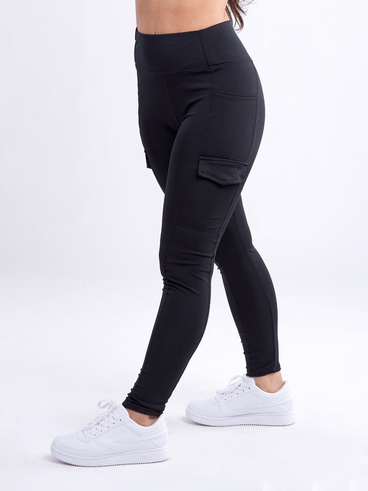 a person's legs in black pants and white sneakers