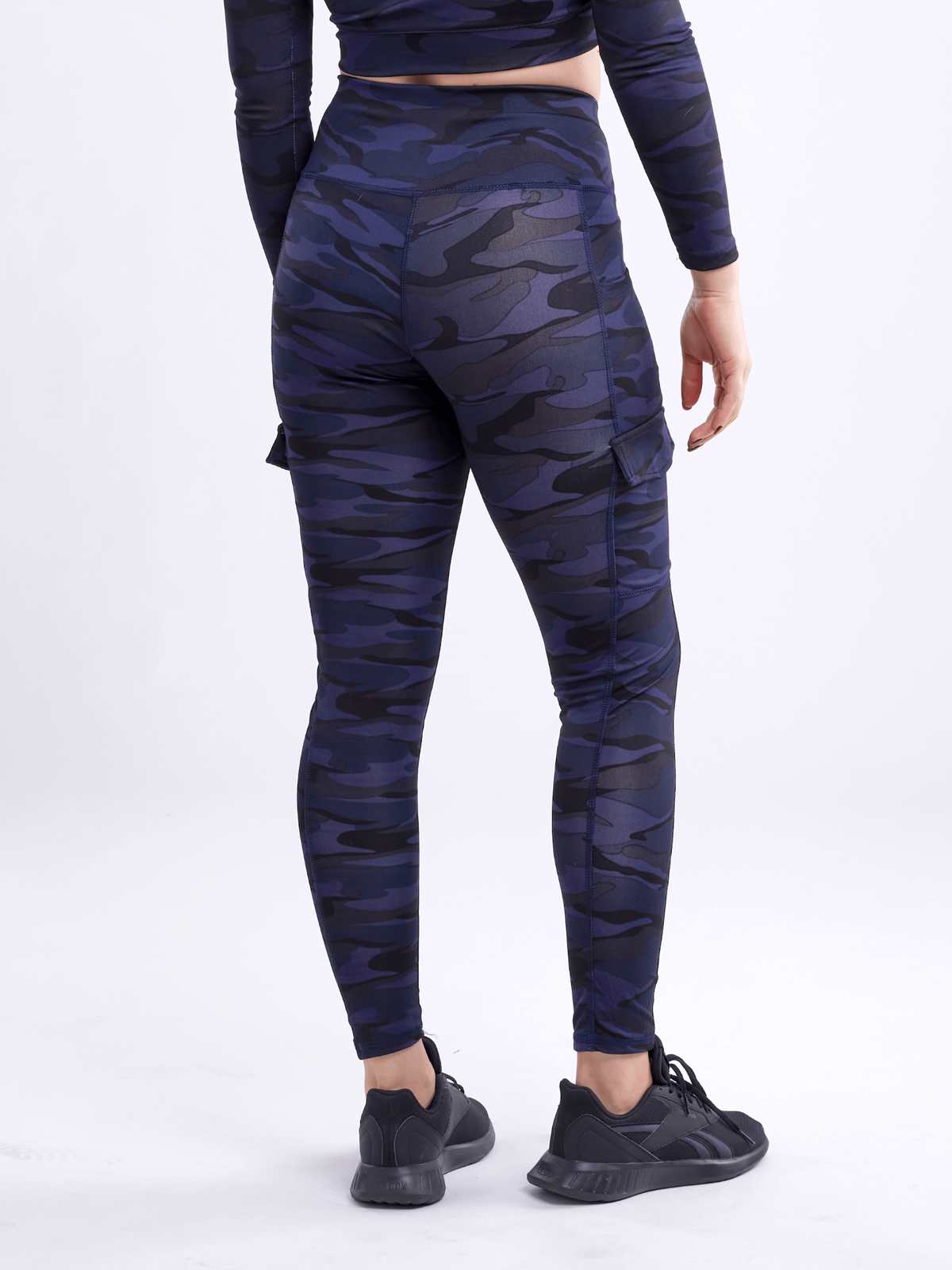 a person wearing a camouflage leggings