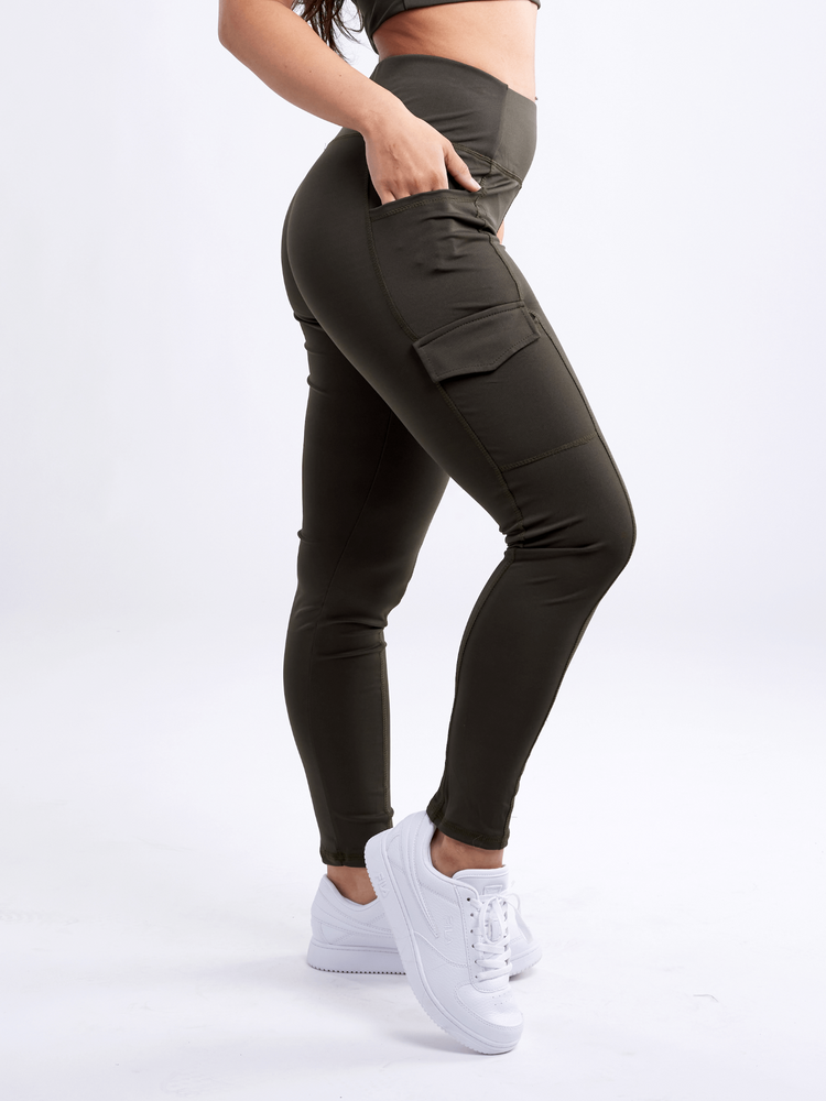 a woman wearing black pants and white sneakers