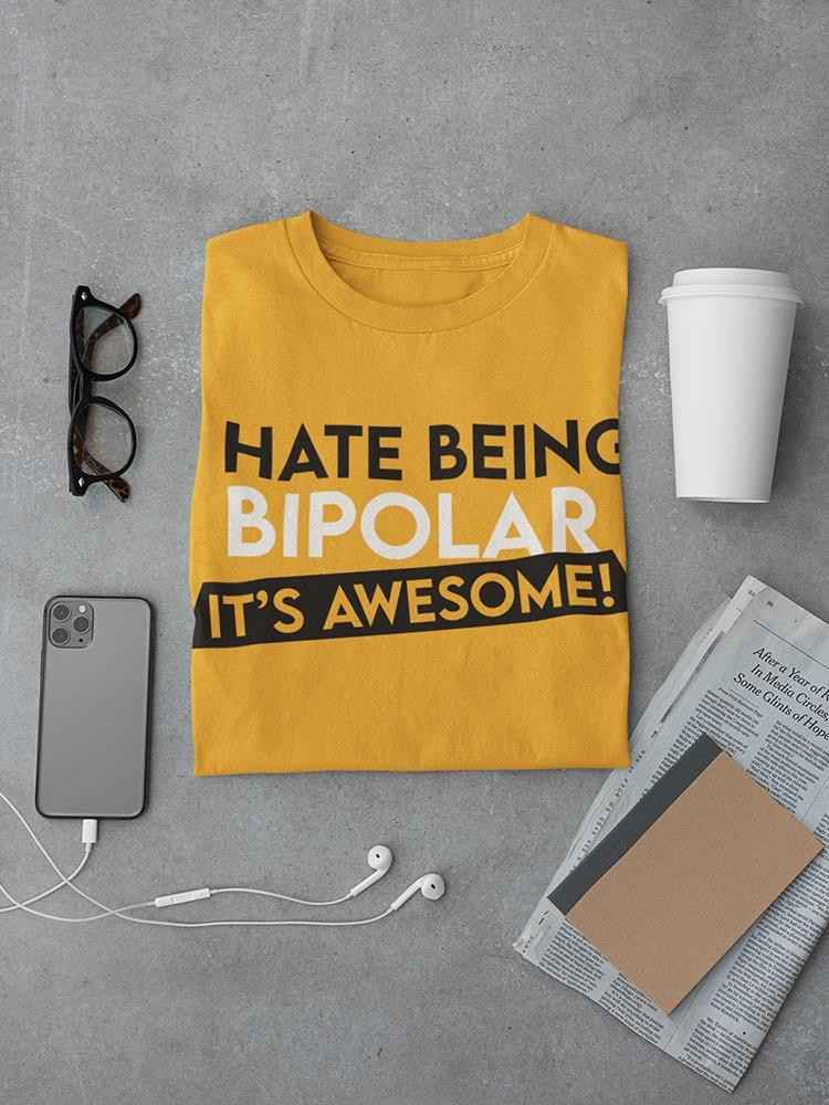 a yellow shirt with a white cup and a phone and glasses