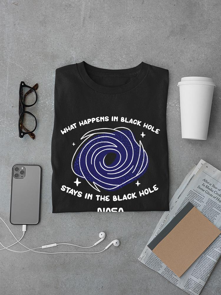 a black shirt with a blue spiral on it next to a phone and a newspaper