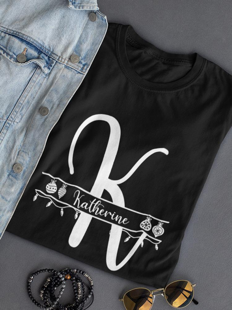 a black shirt with a white letter on it