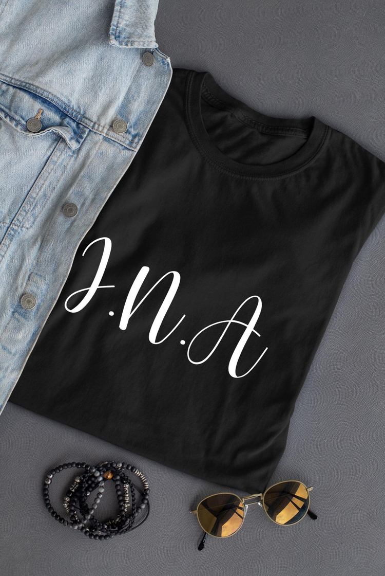 a black shirt with white text on it next to a jean jacket