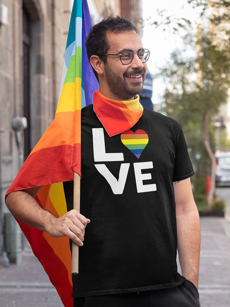 a man holding a rainbow flag