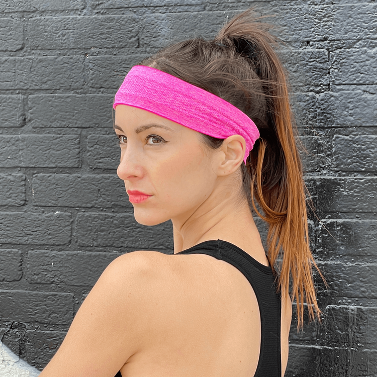 a woman wearing a pink headband