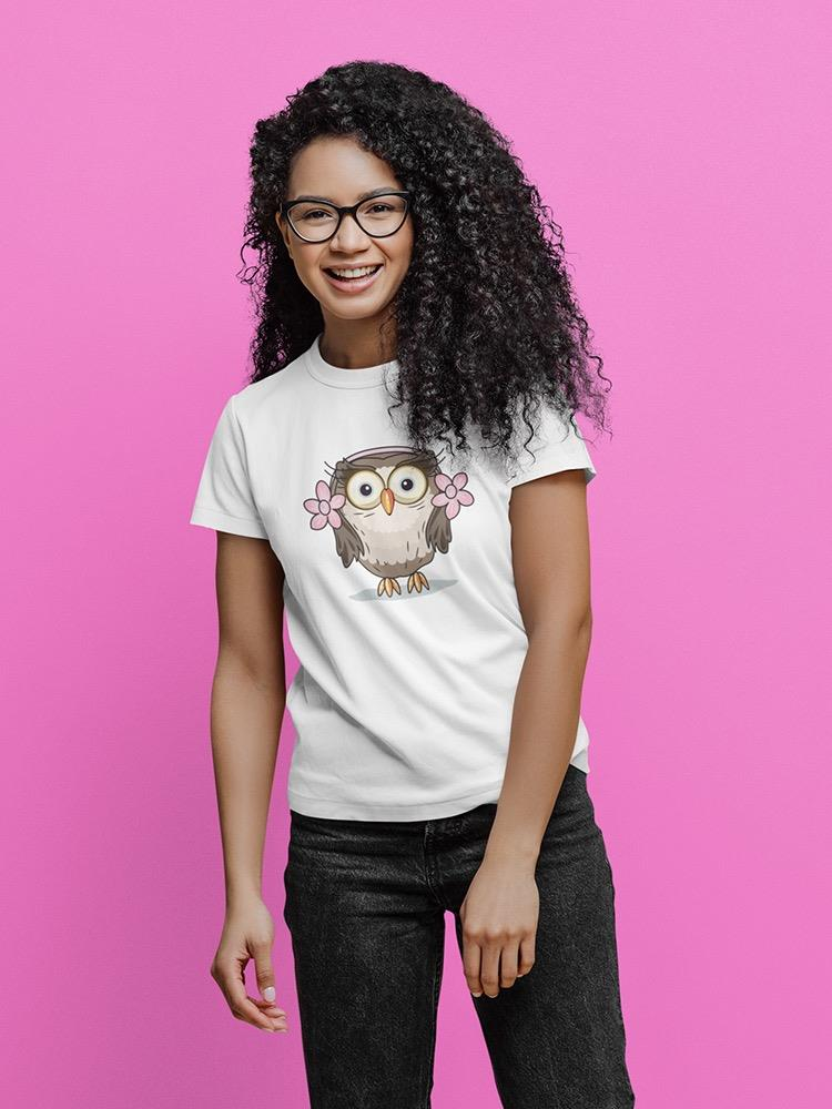a woman wearing glasses and a white shirt with an owl on it