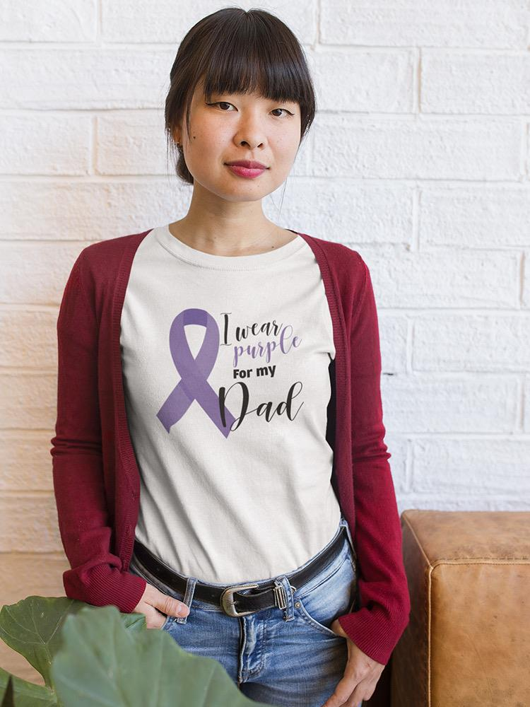 a woman standing in front of a white brick wall