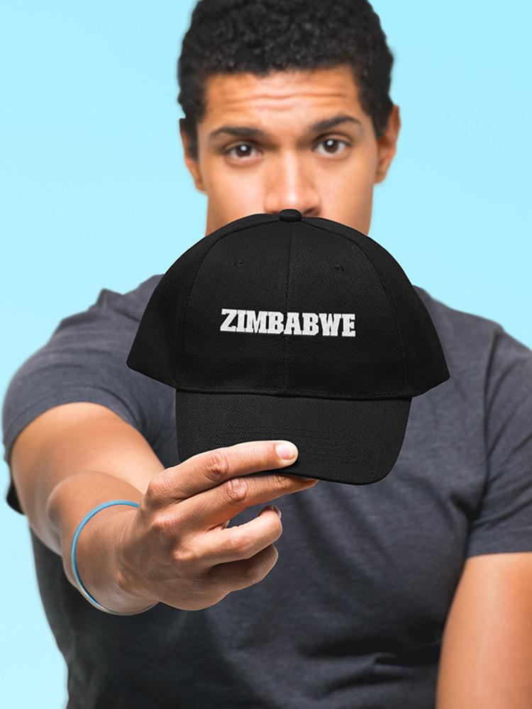 a man holding a black hat