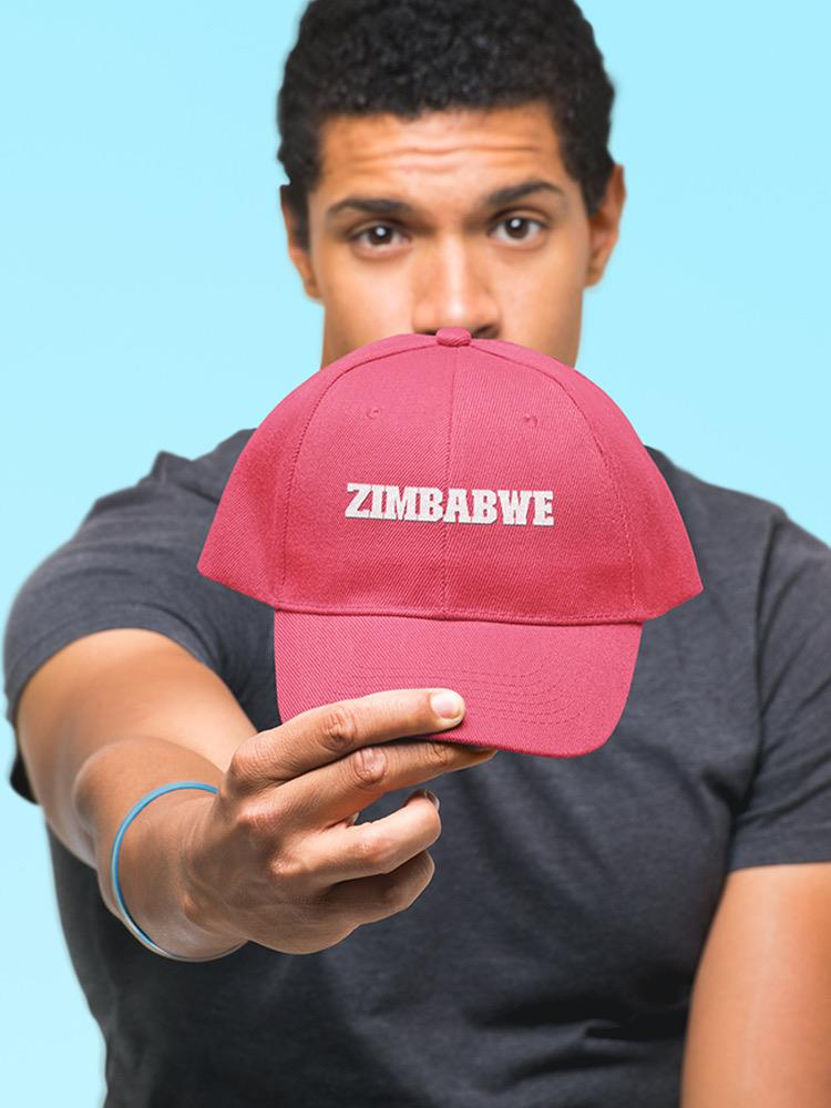a man holding a red hat