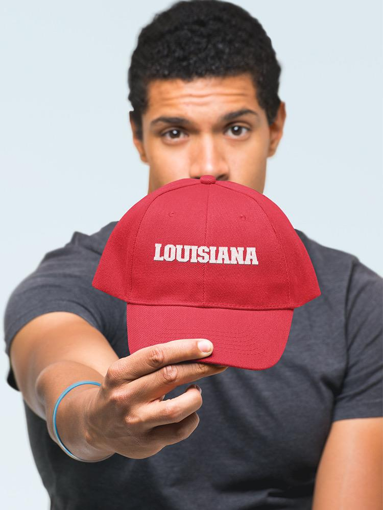 a man holding a red hat