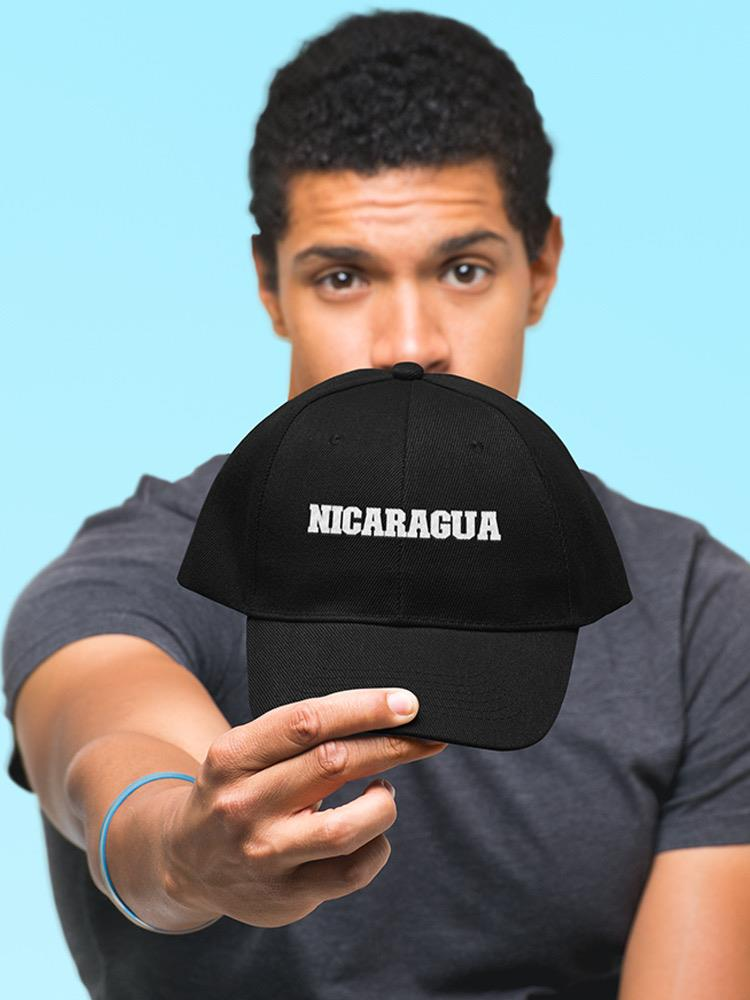 a man holding a black hat