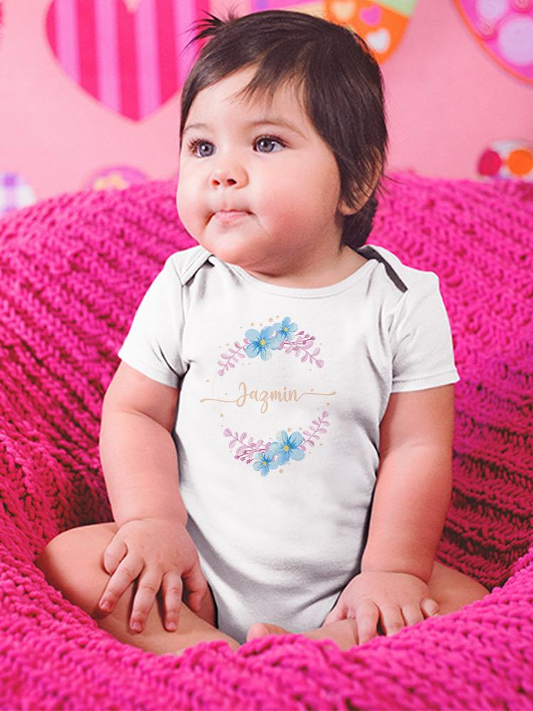 a baby sitting on a pink blanket